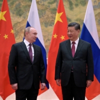 Russian President Vladimir Putin attends a meeting with Chinese President Xi Jinping in Beijing on Feb. 4, the opening day of China\'s 2022 Olympic Winter Games.

  | SPUTNIK / KREMLIN / VIA REUTERS