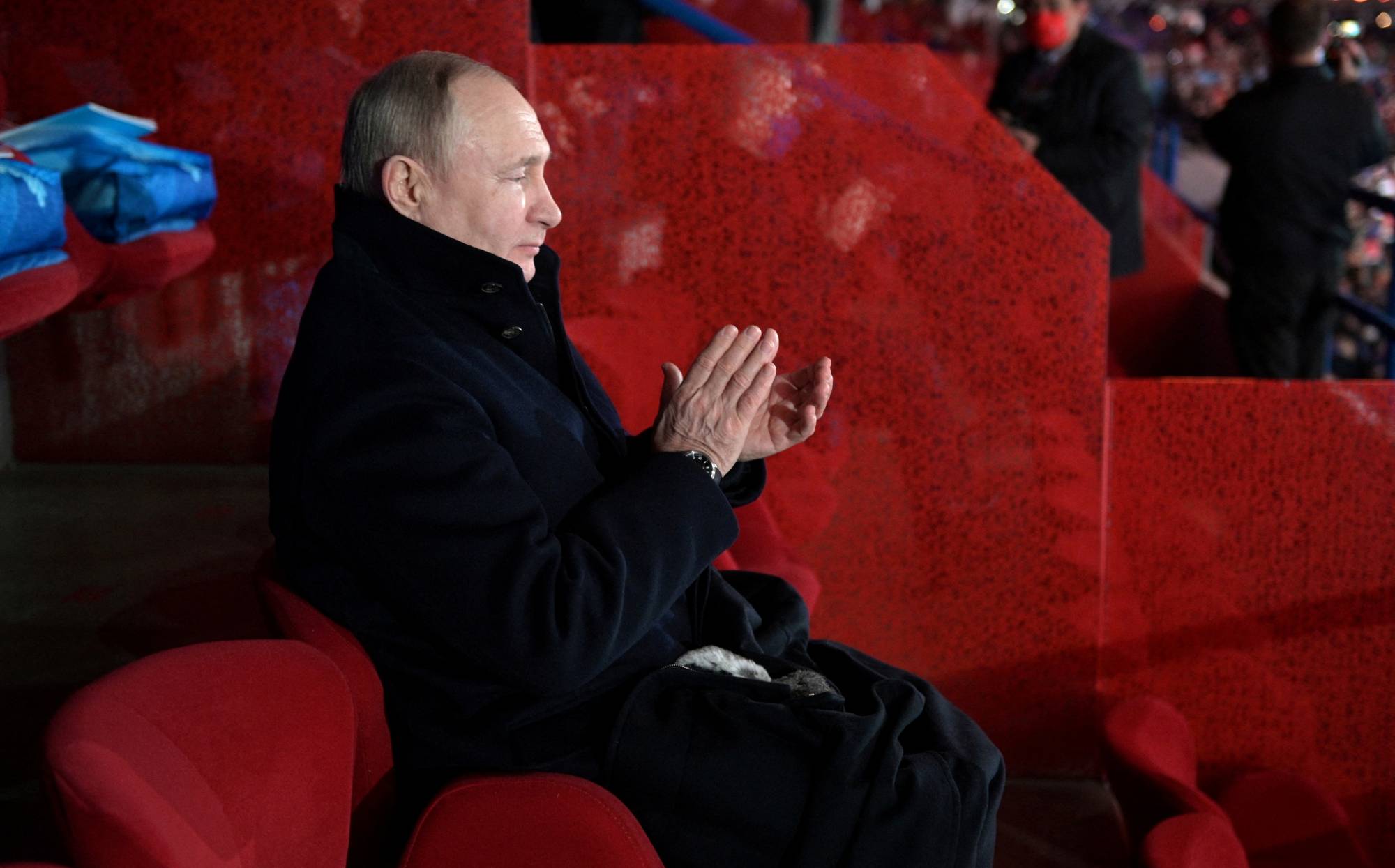 Russian President Vladimir Putin applauds during the opening ceremony of the 2022 Beijing Winter Olympics on Feb. 4. | Kremlin / via REUTERS