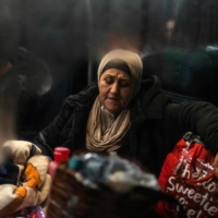 A woman sits inside a train as refugees coming from Ukraine arrive at the North Railway Station in Bucharest on Friday. | AFP-JIJI