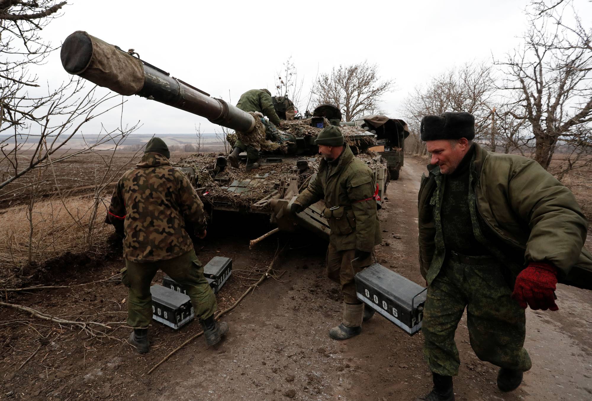 Pro-Russian separatists examine an abandoned tank in the Donetsk region of Ukraine on Tuesday. It’s difficult to know for sure whether Chinese leader Xi Jinping was aware of Russia plans, but state media were certainly left scrambling to manage the message after the Ukraine invasion.   | REUTERS