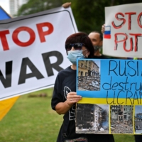 A Ukranian citizen takes part in a demonstration against the Russian invasion of Ukraine in Panama City on Wednesday.  | AFP-JIJI