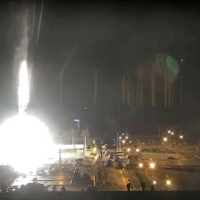 Surveillance camera footage shows a flare landing at the Zaporizhzhia nuclear power plant during shelling in Enerhodar, Ukraine, on Friday in this screen grab taken from YouTube.  | REUTERS  