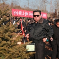 North Korean leader Kim Jong Un takes part in an event to plant trees with ruling party officials on Wednesday.  | KCNA / VIA REUTERS