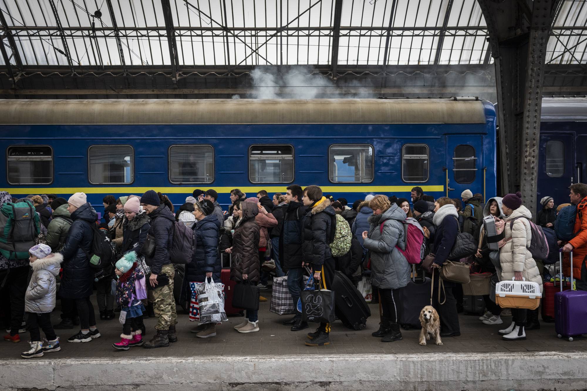 Ukrainians flee Lviv at a train station as Russians invade the country, on Wednesday. The multinational response to Russia's invasion of Ukraine has shown that the demise of the global postwar rules-based order may not be inevitable. | Ivor Prickett/The New York Times