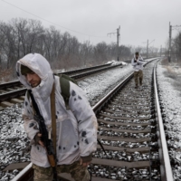Ukrainian Marines patrol along railroad tracks in Verkhnotoretske, Ukraine, on  Feb. 9.  | TYLER HICKS / THE NEW YORK TIMES