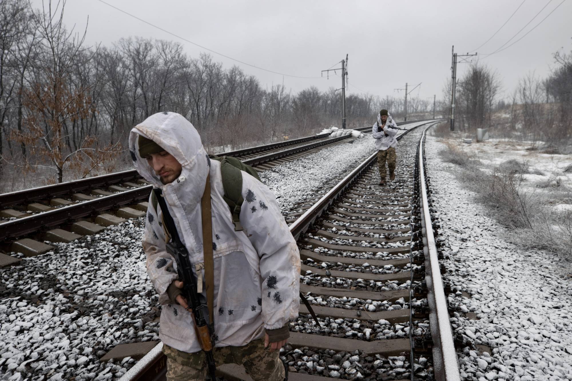 Ukrainian Marines patrol along railroad tracks in Verkhnotoretske, Ukraine, on Feb. 9. | Tyler Hicks / The New York Times