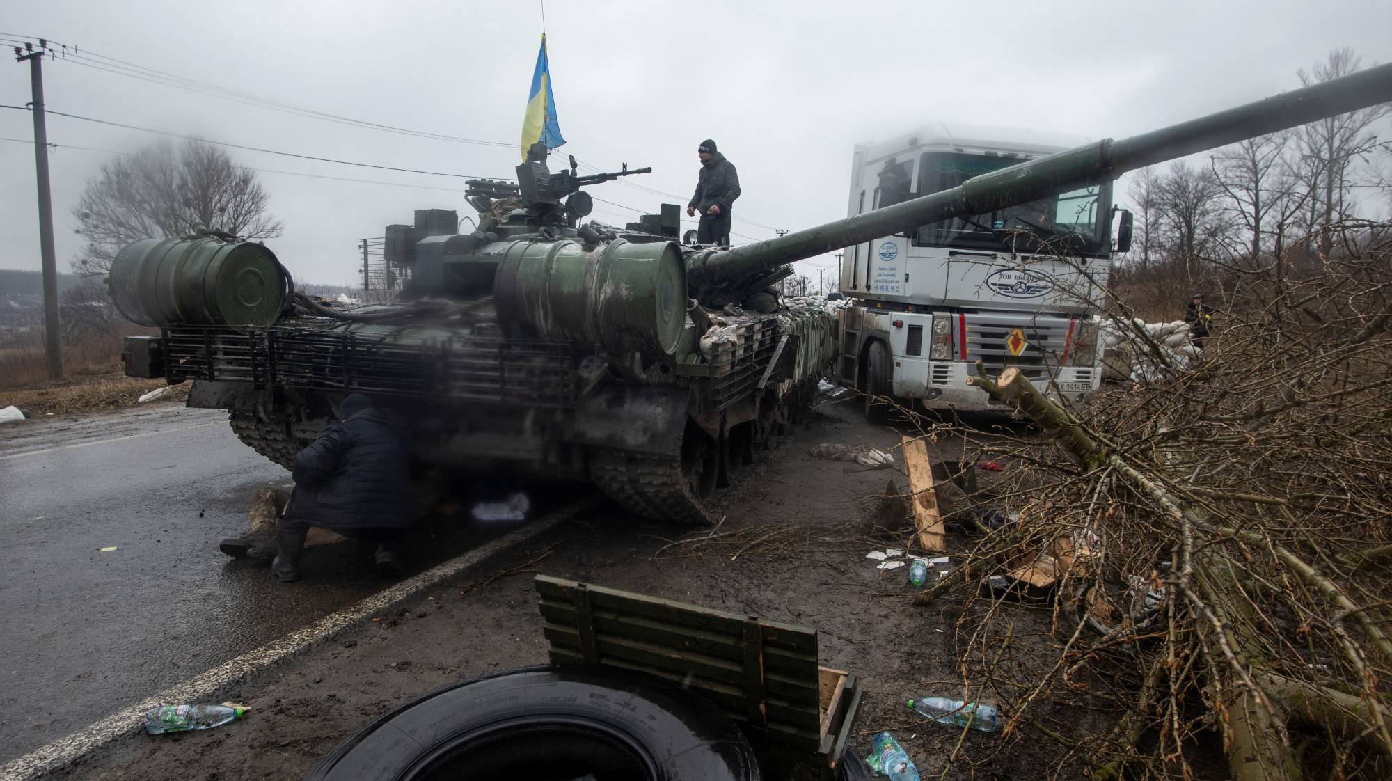 A Ukrainian serviceman stands at a captured Russian tank in the north of the Kharkiv region on Wednesday. | REUTERS 