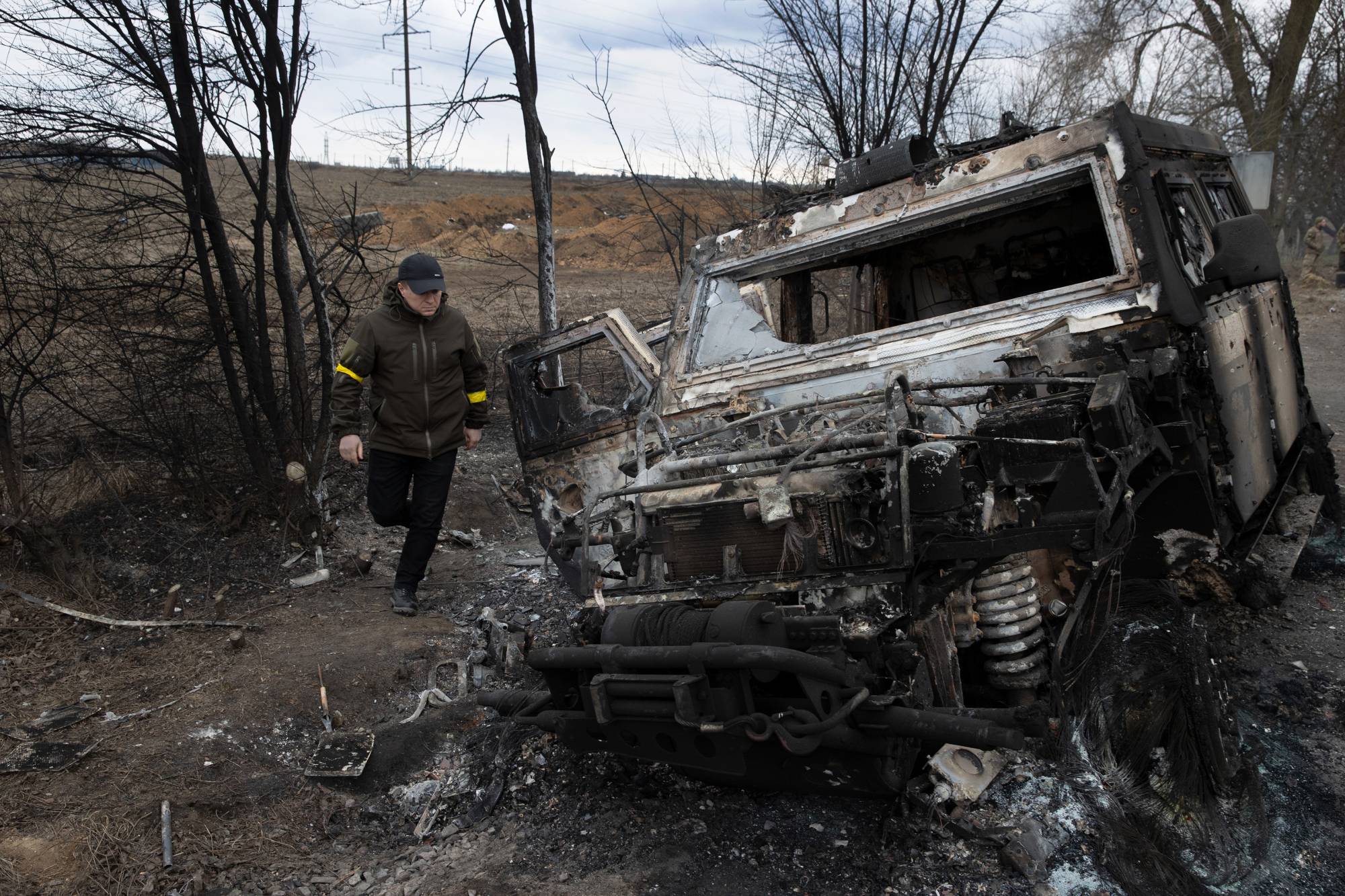 A man walks past a Russian military vehicle destroyed in fighting near Mykolaiv, Ukraine. | TYLER HICKS / THE NEW YORK TIMES