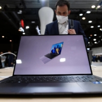 A visitor checks a laptop from the Chinese tech giant Huawei at the MWC (Mobile World Congress) in Barcelona on Tuesday. | AFP-JIJI