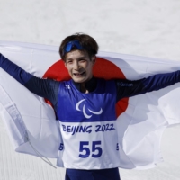 Taiki Kawayoke celebrates after taking gold in the long-distance classical technique standing event at the Beijing Games on Monday. | REUTERS