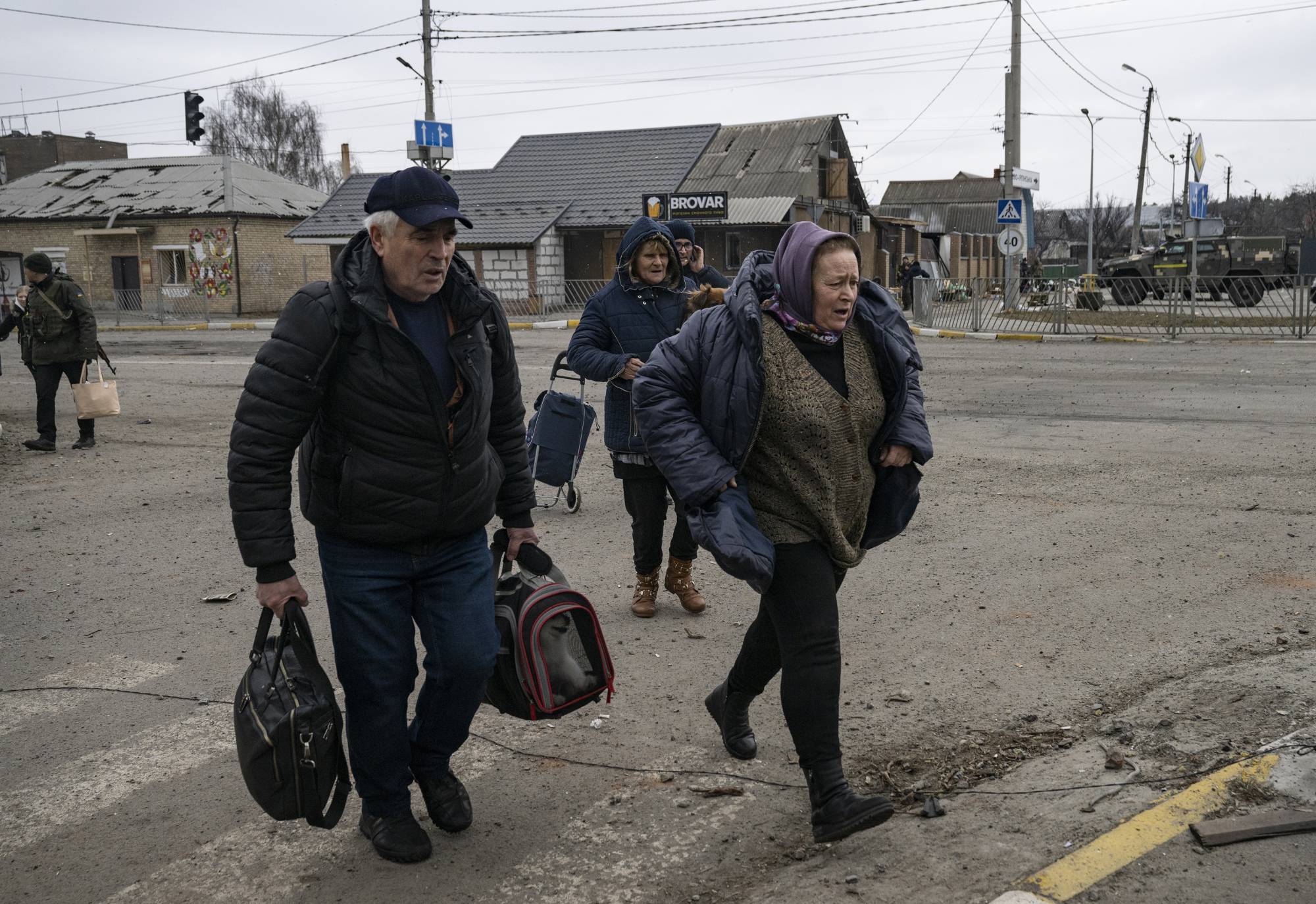 Civilians flee the village of Irpin, near Kyiv, on Sunday. | Lynsey Addario/The New York Times