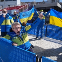 Valerii Sushkevych, president of Ukraine\'s Paralympic committee, celebrates as Oksana Shyshkova receives her gold medal for a cross-country skiing event at the Beijing Paralympics in Zhangjiakou, China, on Monday. | CHANG W. LEE / THE NEW YORK TIMES