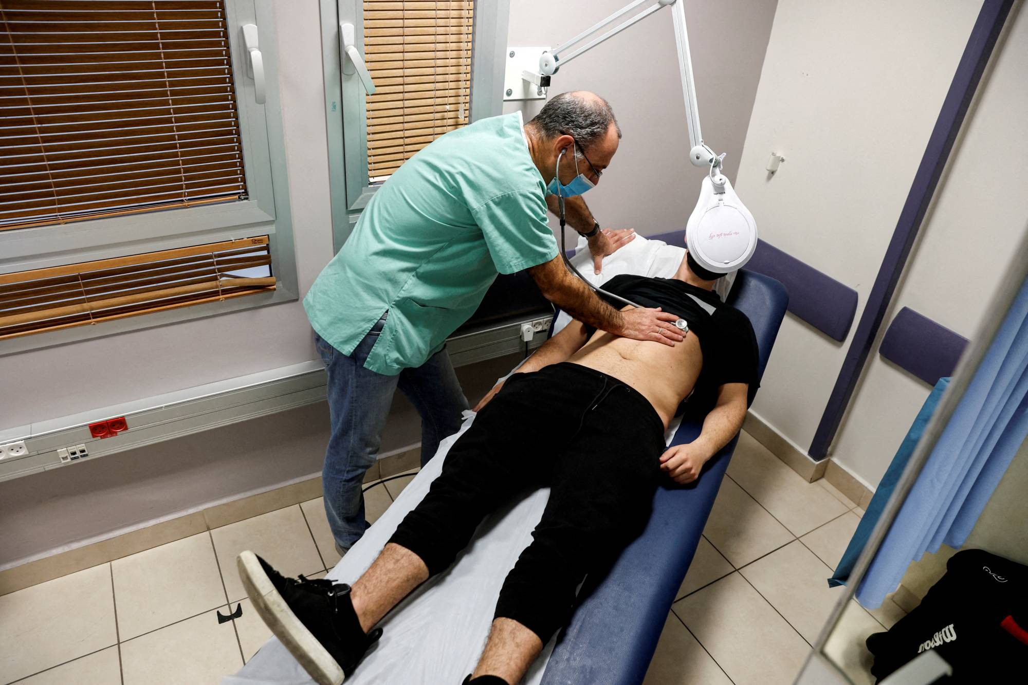 A patient suffering from long COVID is examined in the post-coronavirus disease clinic of Ichilov Hospital in Tel Aviv in Feb., 2022. | REUTERS