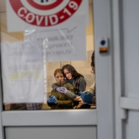 Medical staff embrace while awaiting wounded patients at Clinical Hospital No. 7 in Kyiv on Tuesday.  | LYNSEY ADDARIO/THE NEW YORK TIMES