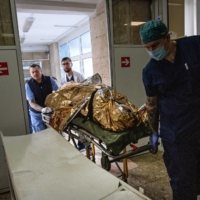 A wounded soldier is brought into Clinical Hospital No. 7 in Kyiv on Tuesday.  | LYNSEY ADDARIO/THE NEW YORK TIMES