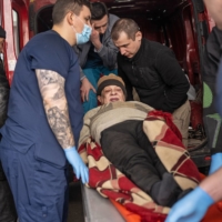 Iryna Vorobyova, 68, arrives at Clinical Hospital No. 7 in Kyiv after spending three days in a basement awaiting evacuation under heavy shelling in Irpin.  | LYNSEY ADDARIO/THE NEW YORK TIMES