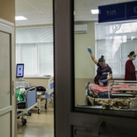 Nurses at Clinical Hospital No. 7 in  Kyiv attend to a wounded soldier on Tuesday.  | LYNSEY ADDARIO/THE NEW YORK TIMES