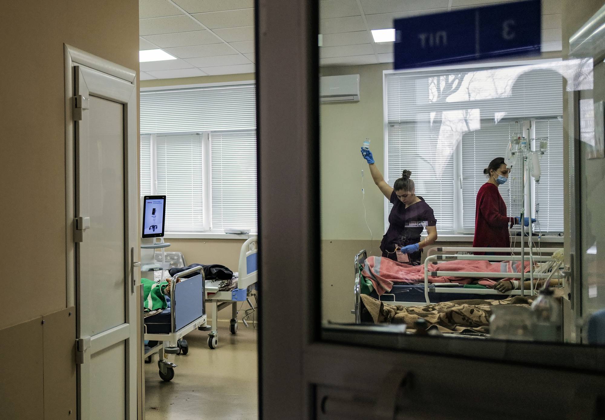 Nurses at Clinical Hospital No. 7 in Kyiv attend to a wounded soldier on Tuesday. | Lynsey Addario/The New York Times