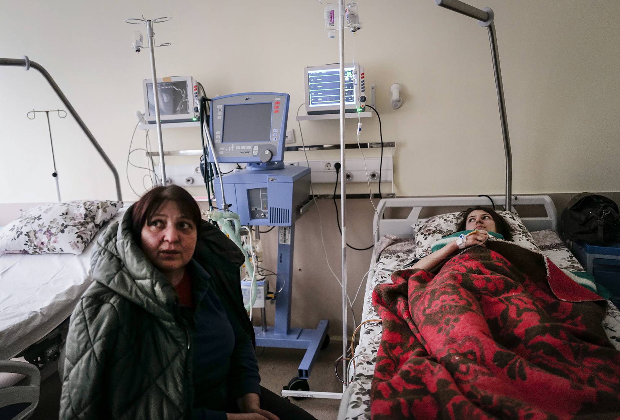 Myroslava Svystovych sits with her wounded daughter, Lada, who was shot in Irpin, Ukraine. | Lynsey Addario/The New York Times