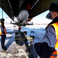 Russian airmen examine a Tu-95MS, an air-launched cruise missile, during an exercise at an undisclosed location in Russia on Feb. 19. | RUSSIAN DEFENCE MINISTRY / VIA AFP-JIJI