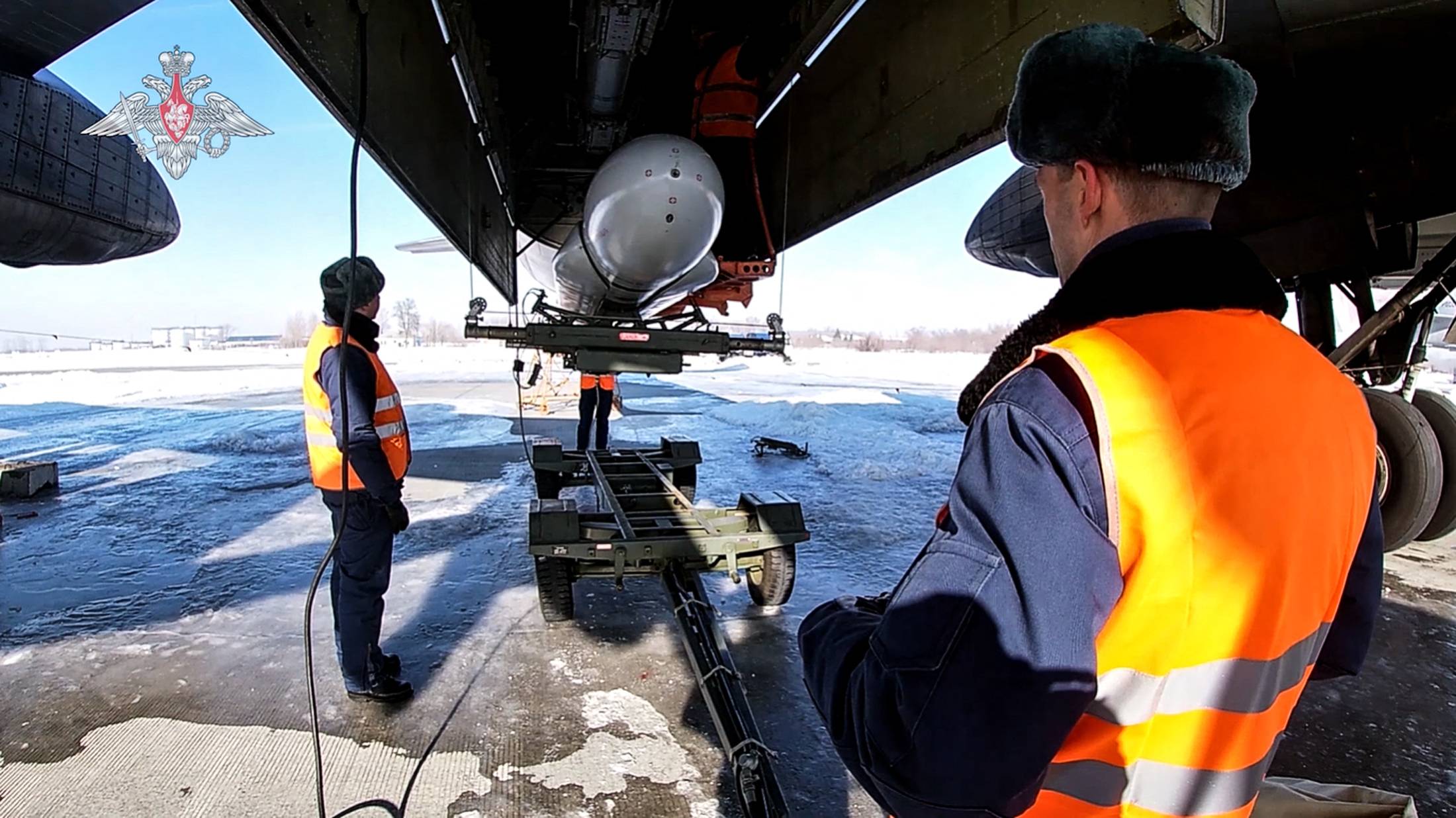 Russian airmen examine a Tu-95MS, an air-launched cruise missile, during an exercise at an undisclosed location in Russia on Feb. 19. | RUSSIAN DEFENCE MINISTRY / VIA AFP-JIJI