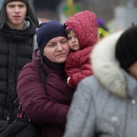 Refugees wait at the Ukrainian-Slovakian border after fleeing Russia\'s invasion of Ukraine, in Vysne Nemecke, Slovakia, on March 5.  | REUTERS