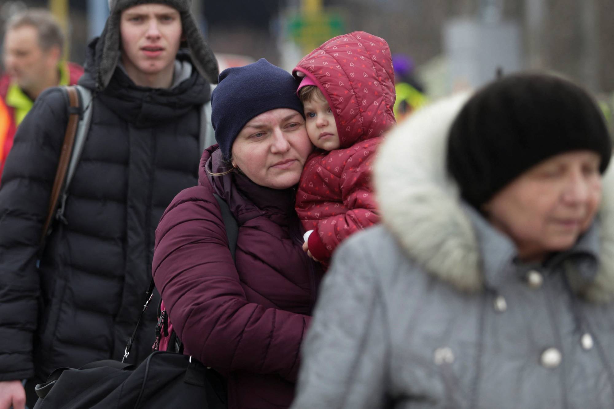 Refugees wait at the Ukrainian-Slovakian border after fleeing Russia's invasion of Ukraine, in Vysne Nemecke, Slovakia, on March 5.  | REUTERS