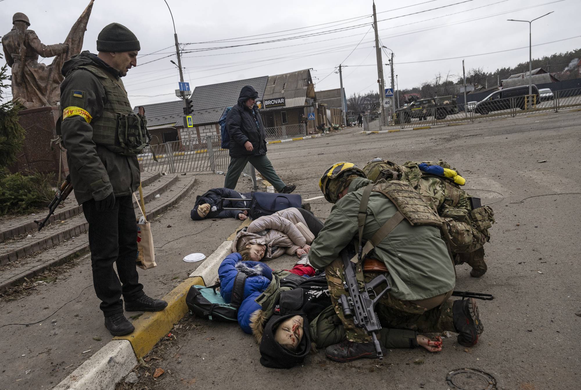 Moments after four civilians trying to evacuate were hit by Russian mortar fire, Ukrainian soldiers try to save Anatoly Berezhnyi — the only one who still had a pulse — in Irpin, west of Kyiv, on Sunday. Serhiy said he felt it was important the deaths of his wife and children had been recorded in photographs and video. 