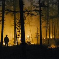 Volunteers battle a forest fire in Magaras, Siberia, Russia on July 8, 2021. The region is usually known for its bone-chilling cold, but recent summer temperatures have reached as high as 100 degrees Fahrenheit (37.8 degrees Celsius). | NANNA HEITMANN / THE NEW YORK TIMES