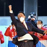 South Korea\'s new president-elect, Yoon Suk-yeol, celebrates his victory outside his People Power Party\'s headquarters in Seoul on Thursday. | AFP-JIJI