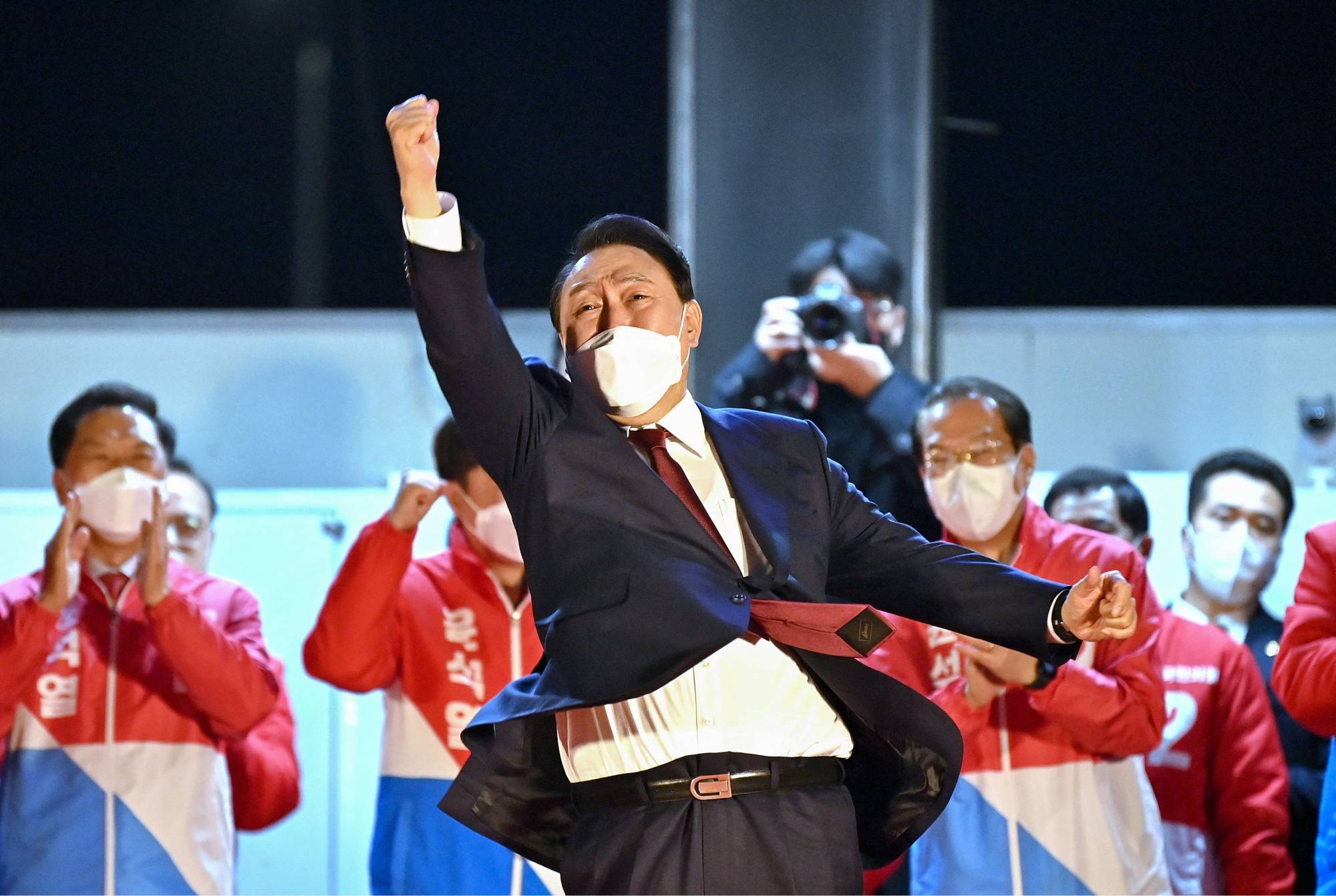 South Korea's new president-elect, Yoon Suk-yeol, celebrates his victory outside his People Power Party's headquarters in Seoul on Thursday. | AFP-JIJI