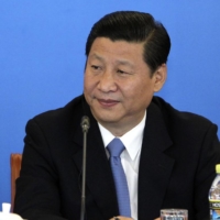 Then-U.S. Vice President Joe Biden speaks alongside then-Chinese Vice President Xi Jinping at a China-U.S. Business Dialogue event in Beijing in August 2011. | REUTERS