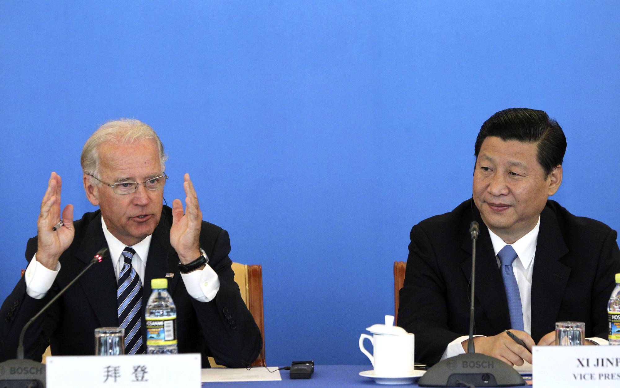Then-U.S. Vice President Joe Biden speaks alongside then-Chinese Vice President Xi Jinping at a China-U.S. Business Dialogue event in Beijing in August 2011. | Reuters