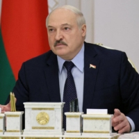 Belarusian President Alexander Lukashenko chairs a meeting with military officials in Minsk, Belarus, on Feb. 24. | BELTA HANDOUT / VIA REUTERS