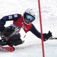 Japan\'s Momoka Muraoka is seen in action during her first run Saturday at the Beijing 2022 Winter Paralympic Games at the National Alpine Skiing Center in Beijing\'s Yanqing district. | REUTERS