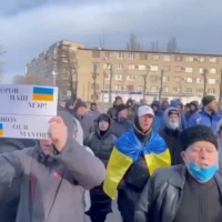 Ukrainians protest the abduction of Mayor Ivan Fedorov outside the Melitopol regional administration building on Saturday. The mayor was reportedly taken away by invading Russian forces. | UKRAINE / VIA REUTERS