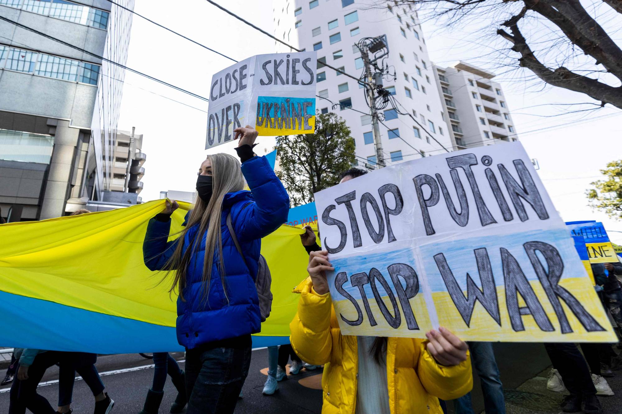Demonstrators march in Tokyo on March 5 during a protest against Russia's actions in Ukraine. | AFP-Jiji