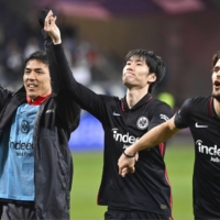 Daichi Kamada (center) and Makoto Hasebe (left) celebrate with a teammate after Eintracht Frankfurt\'s win over Bochum on Sunday. | KYODO
