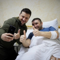 Ukrainian President Volodymyr Zelenskyy visits an injured serviceman at a military hospital, as Russia\'s attack on Ukraine continues, in Kyiv on Sunday.  | UKRAINIAN PRESIDENTIAL PRESS SERVICE / VIA REUTERS