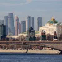 Skyscraper office buildings loom over the Moscow International Business Center (MIBC), also known as Moscow City, and the Grand Kremlin palace, right, as viewed from the River Moskva in Moscow on Feb. 15.  | BLOOMBERG