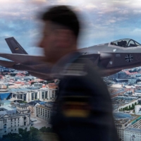 A poster advertising Lockheed Martin\'s F-35 stealth fighter jet over a Berlin skyline is seen at the Berlin Security Conference in 2017. Germany plans to buy up to 35 of the fighters as part of a major push to modernize its armed forces in response to Russia\'s invasion of Ukraine.  | AFP-JIJI