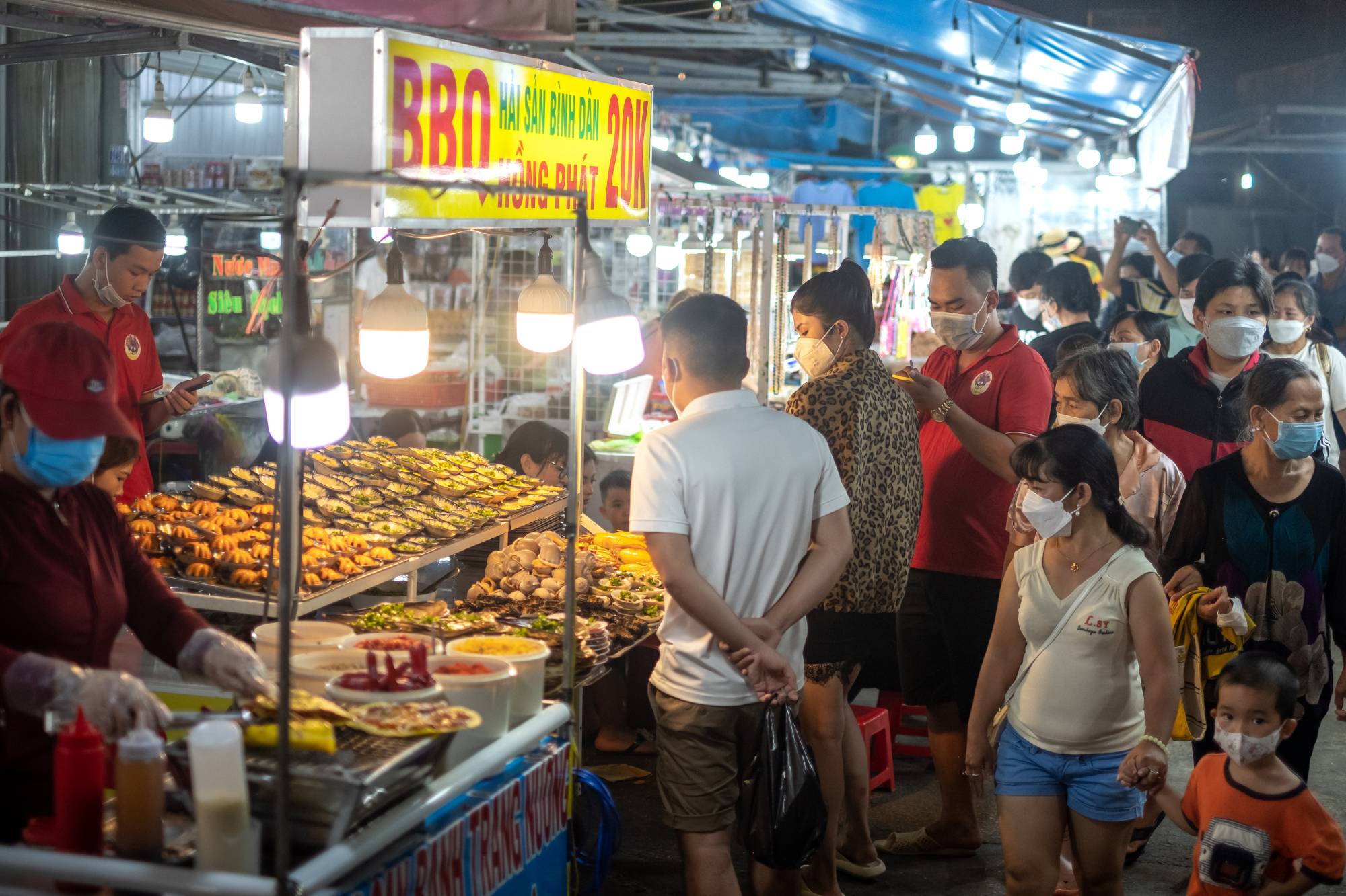 Visitors gather at a night market on Phu Quoc Island in Vietnam, on Feb. 26. Vietnam announced that it would open its borders on March 15 to international tourists, with a one-day hotel isolation. | Linh Pham / The New York Times 
