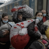 A family that fled the fighting in Ukraine arrives at a train station in Budapest on March 5. | MAURICIO LIMA / THE NEW YORK TIMES
