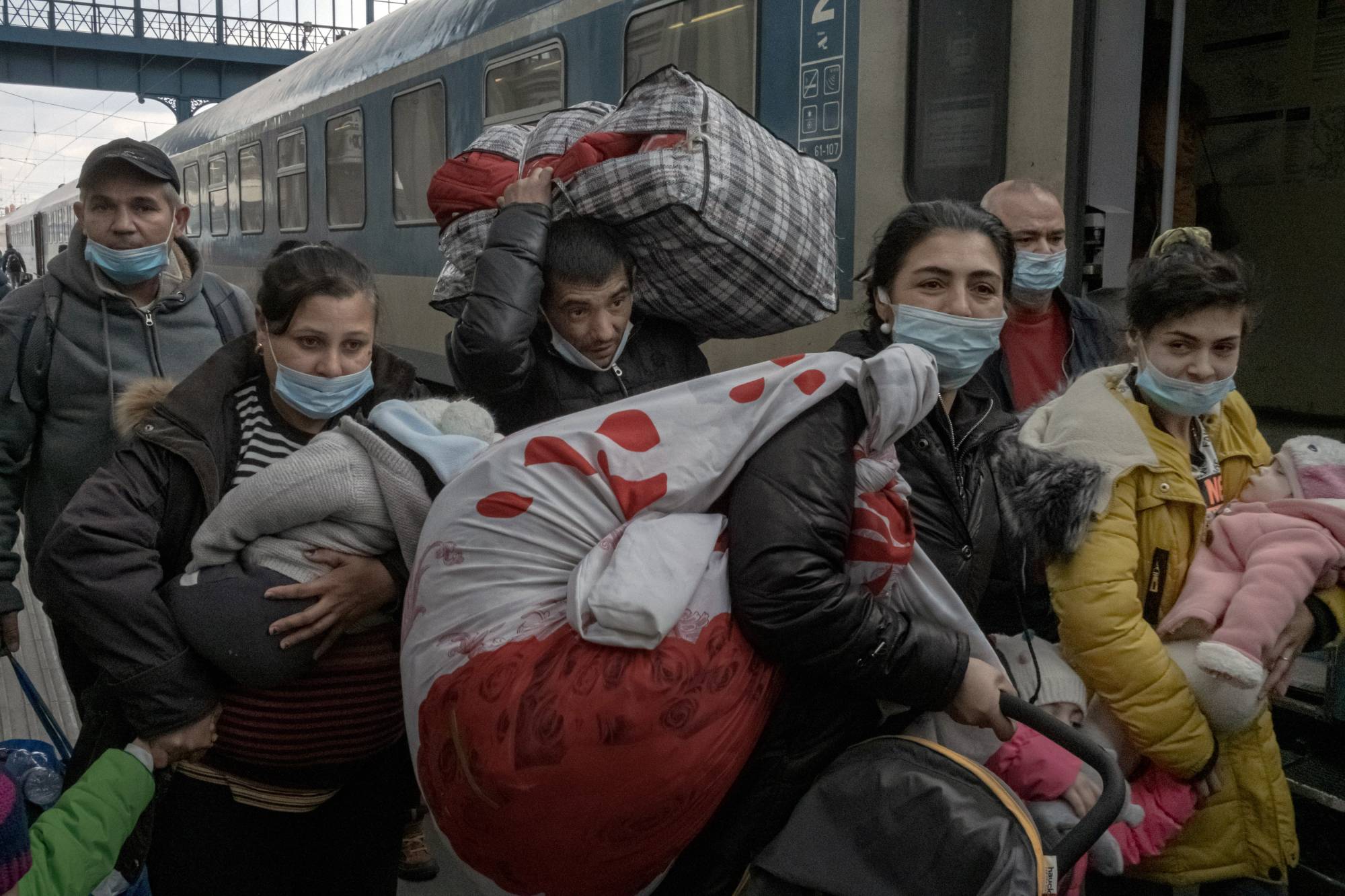 A family that fled the fighting in Ukraine arrives at a train station in Budapest on March 5. | Mauricio Lima / The New York Times