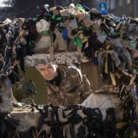 A Ukrainian serviceman stands guard at a military checkpoint in Kyiv on Tuesday. | AFP-JIJI