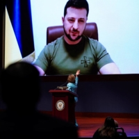 Ukrainian President Volodymyr Zelenskyy delivers a video address to senators and members of the U.S. House of Representatives gathered in the Capitol Visitor Center Congressional Auditorium in Washington on Tuesday. | REUTERS
