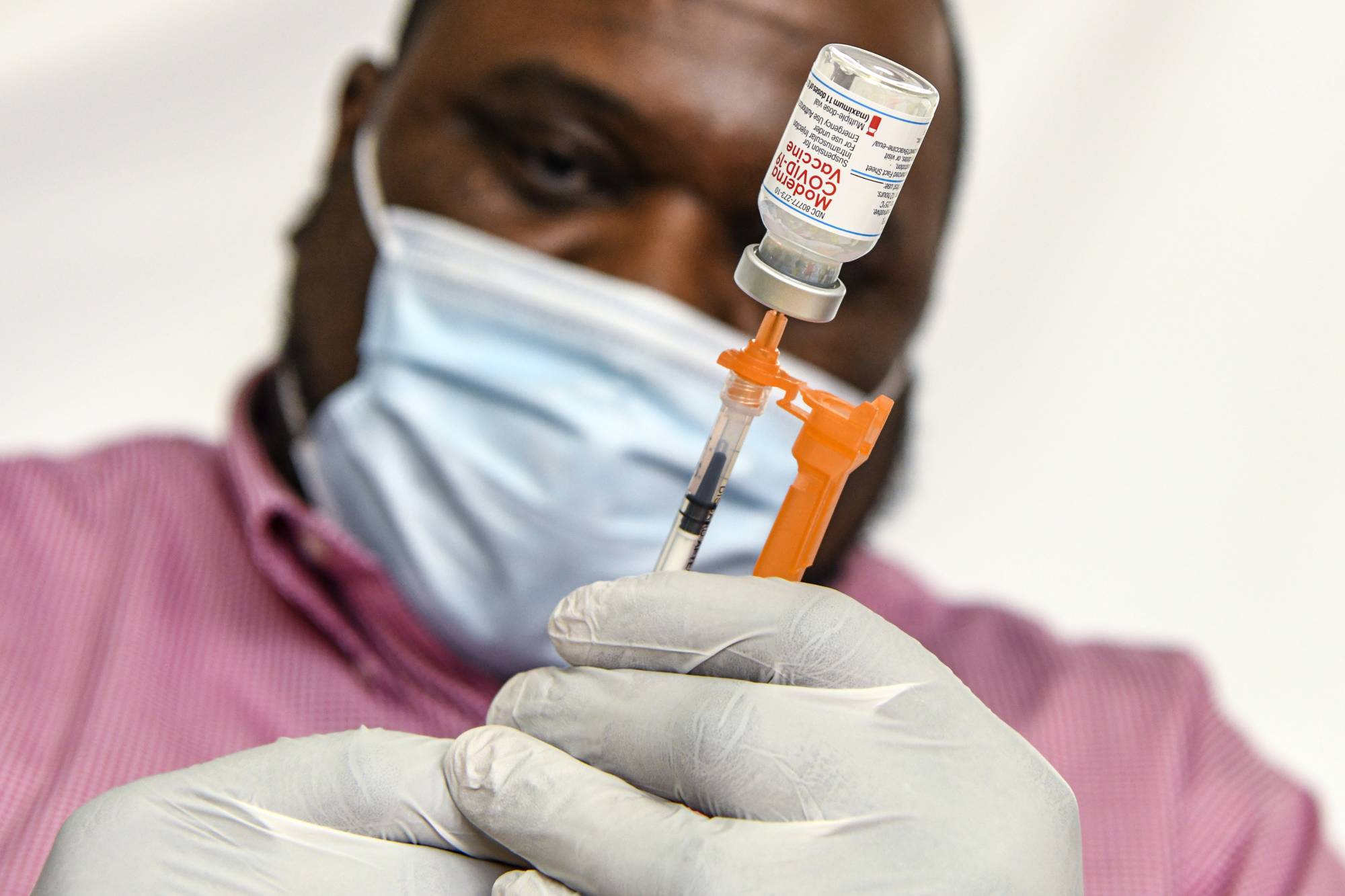 A pharmacist prepares doses of the Moderna COVID-19 vaccine in Hagerstown, Maryland, on Feb. 22. | Kenny Holston / The New York Times