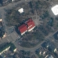 A satellite image showing the Mariupol Drama Theater in Mariupol, Ukraine, on Monday. The building, which had been used as a shelter for hundreds of Ukrainian civilians, had the word “children” written in large white letters (in Russian) in front of and behind the theater, was bombed on Wednesday. | MAXAR TECHNOLOGIES / AFP