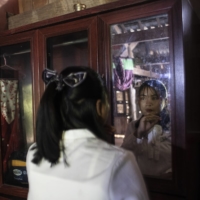 Ma Syloun preparing for her brother’s funeral, in Sna Ansa, Cambodia, Jan. 23. “I don’t want to think about this terrible history. It’s better to look forward,” she said. | NADIA SHIRA COHEN / THE NEW YORK TIMES