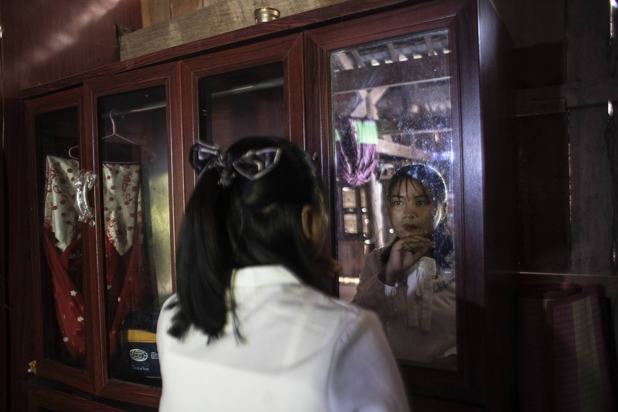 Ma Syloun preparing for her brother’s funeral, in Sna Ansa, Cambodia, Jan. 23. “I don’t want to think about this terrible history. It’s better to look forward,” she said. | Nadia Shira Cohen / The New York Times